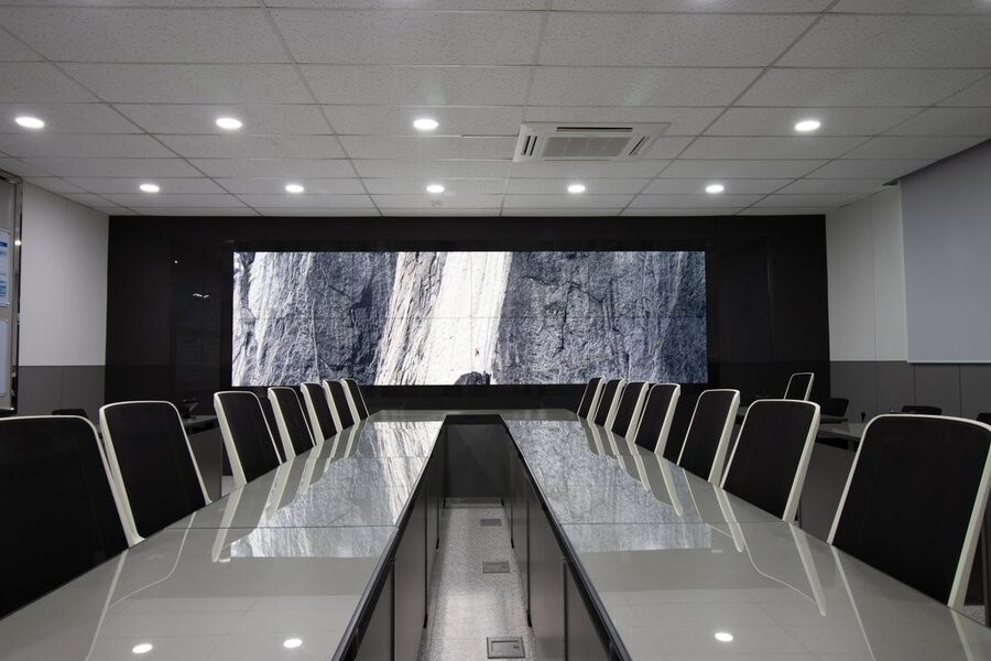 A conference room space featuring digital signage in the form of a video wall.